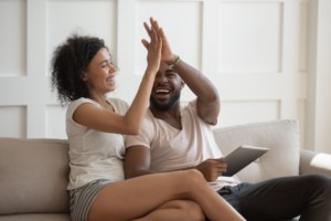 A couple gives each other a high-five over some news