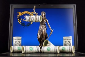 A statute of lady justice holds her scales, with dollar bills around her, in front of a Nevada state flag background.