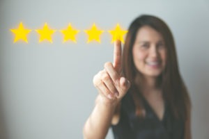 woman selects five-star rating