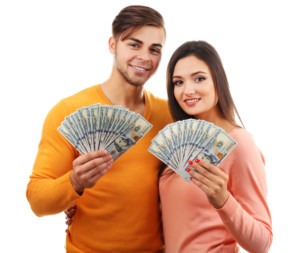 young couple holding cash