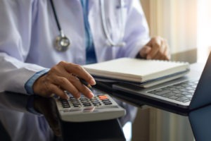 doctor calculates medical bills