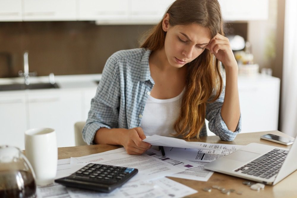 woman stressed looking over bills