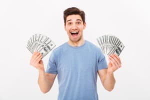excited man holding american money